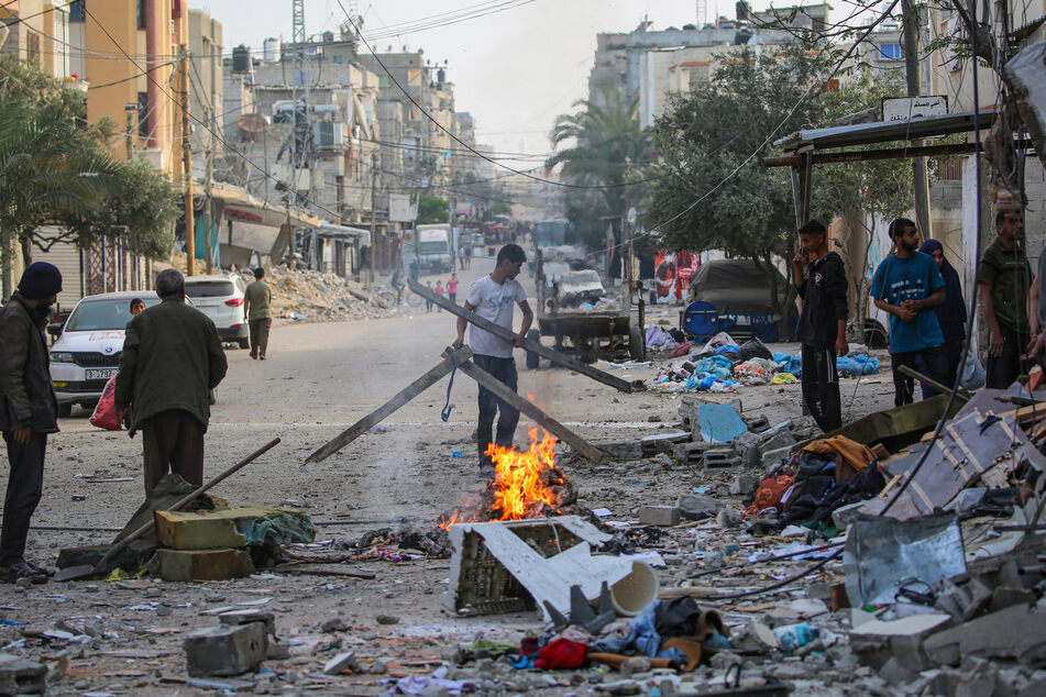 Palestinians salvage items from the rubble of a family house that was hit overnight in Israeli bombardment in the Tal al-Sultan neighbourhood of Rafah in southern Gaza.